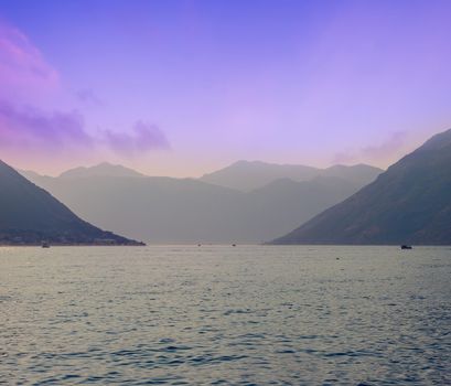 Sunset, beautiful landscape with silhouettes of trees. Travel concept. Montenegro, Kotor Bay. Sunset at Kotor Bay Montenegro. View of the sunset in Boko-Kotor Bay in Montenegro. Silhouettes of mountains. High quality photo