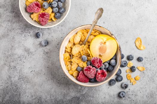 Healthy breakfast bowl, cereals, fresh fruit, berries on table. Clean eating, diet concept. Top view. Healthy bowl with cereals, raspberries, blueberries, plum. Granola. Vegetarian. Selective focus.