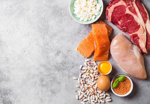 Assortment of natural sources of protein from food: meat, fish, chicken, dairy products, eggs, beans. Diet, healthy eating, wellness, bodybuilding concept, top view, space for text.