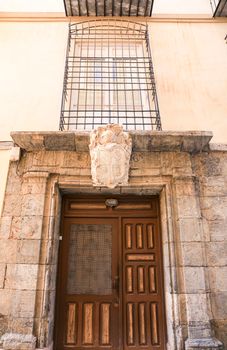 Cartagena, Murcia, Spain- July 18, 2022: Antique house on Adarve street with civilian coat of Arms made of marble