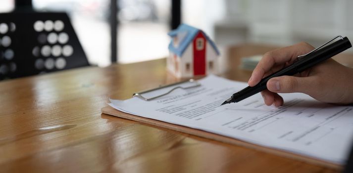 Real estate agent working sign agreement document contract for home loan insurance