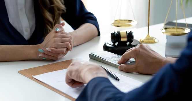 Close-up shot, A male client giving a house loan payment or mortgage fees to his female real estate agent. Property Investment concept.