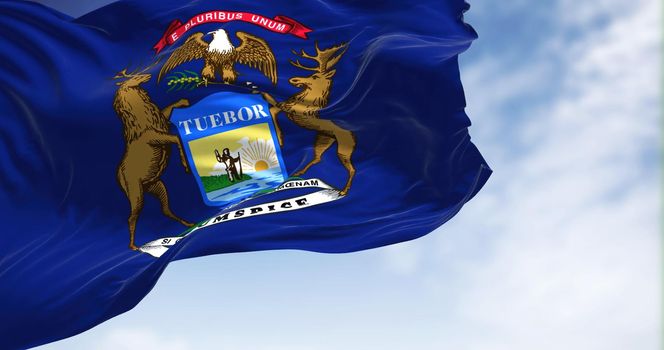 The US state flag of Michigan waving in the wind. MIchigan is a state in the Great Lakes region of the upper Midwestern United States. Democracy and independence.