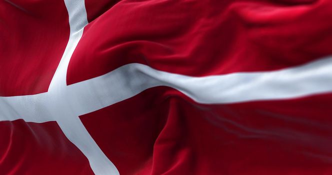 Close-up view of the Denmark national flag waving in the wind. Denmark is a Nordic country in Northern Europe. Fabric texture background. Selective focus
