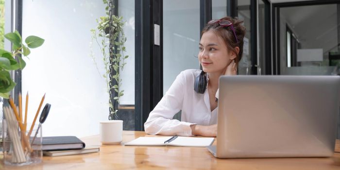 Smiling millennial woman talking on the phone at home, happy young girl holds cellphone making answering call, attractive teenager having pleasant conversation chatting by mobile with friend.