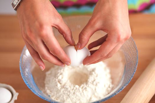 Woman is making cakes in the kitchen.