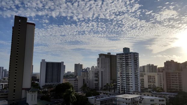 Makiki, and Honolulu Cityscape looking to the ocean from high up at sunset with houses and modern highrises, and other small buildings on a beautiful day June 29 2016.