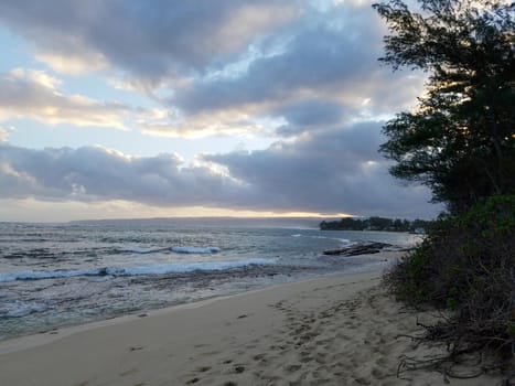 Camp Mokuleia Beach at Dusk looking into the pacific ocean with a clear blue sky on Oahu.