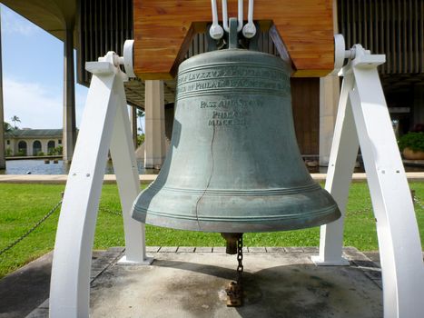 Close-up of Liberty Bell in front of the Hawaii State Capitol. In 1950, the United States Department of the Treasury assisted by several private companies selected Paccard Foundry in Annecy-le-Vieux, France, to cast 55 full-sized replicas of the Liberty Bell.