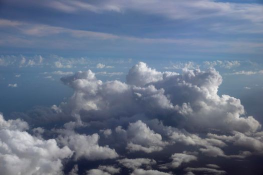 Fluffy Clouds in a blue sky above the Pacific ocean.