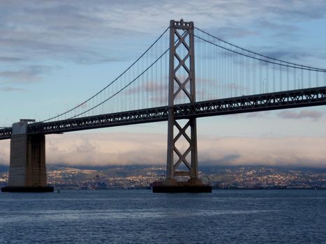 San Francisco side of Bay Bridge with Oakland in the distance on a clear day.