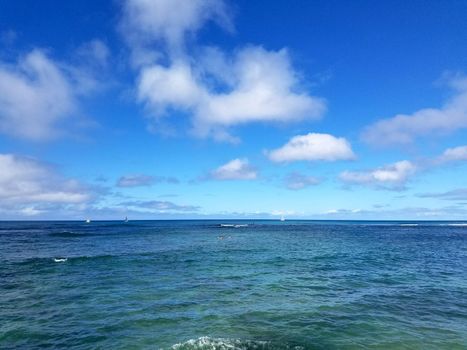 Shades of Turquoise Blue Ocean Water ripples off South Shore of Oahu with boats on ocean.  Taken on August 6, 2016.