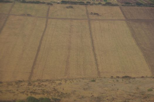 Aerial of empty dry crops fields in Maui, Hawaii.