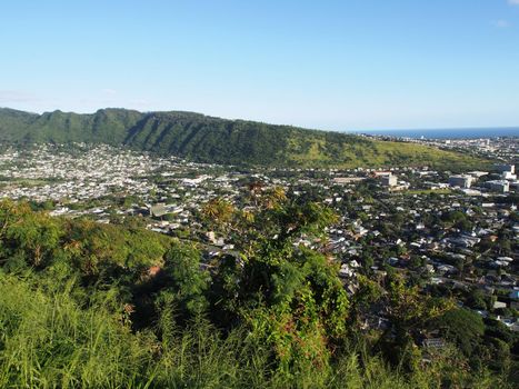 Manoa Valley on the Island of Oahu.  Featuring Mountains, High School, College campus, houses, school and graveyard.