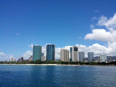 Ala Moana Beach Park with office building and condos in the background during a beautiful day on the island of Oahu, Hawaii. September 18, 2013.