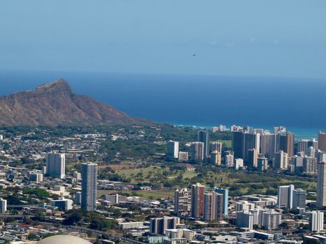 Aerial view of Honolulu Cityscape, Diamondhead, Ala Wai Golf Course, the gold coast, Pacific ocean, and waves with Helicopter in air on Oahu, Hawaii.  March 2016.