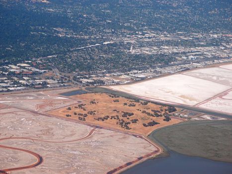 Aerial view of Bedwell Bayfront Park, salt evaporation ponds, cities and nature surrounding San Francisco Bay area near San Jose, California, United States.