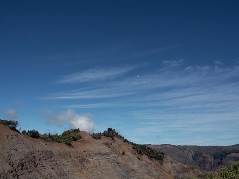 Helicopter flys above Lush Mountains of Waimea Canyon on Kauai, Hawaii