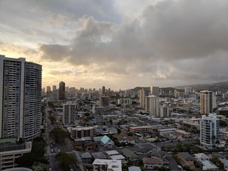 Honolulu -  April 21, 2018:  Aerial of Honolulu Cityscape featuring Buildings, parks, hotels, punchbowl crater and Condos with Pacific Ocean stretching into the distance at dusk on a nice day. 