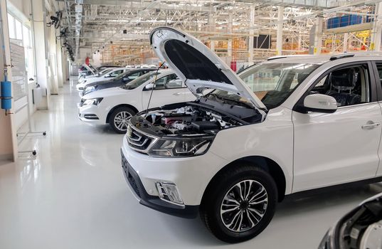 Factory for the production of cars, factory conveyor. Cars are being assembled.