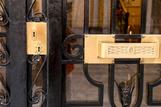 Black forged metal door modernist style with beautiful golden door handle