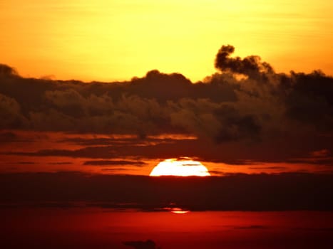 Sunset through the clouds with red yellow sky.