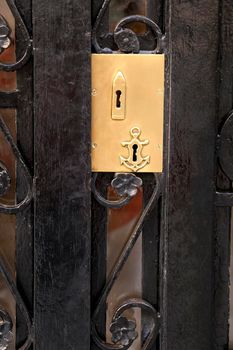 Black forged metal door modernist style with beautiful golden door handle