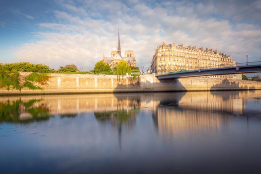 Notre Dame of Paris on Seine River back view at peaceful sunrise, France