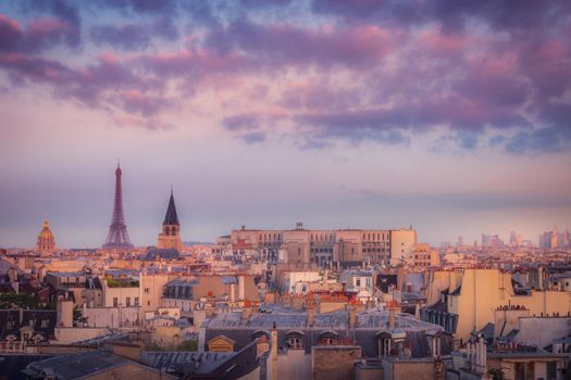 Eiffel tower and parisian roofs at golden sunrise Paris, France