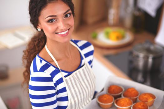 Woman is making cakes in the kitchen, isolated