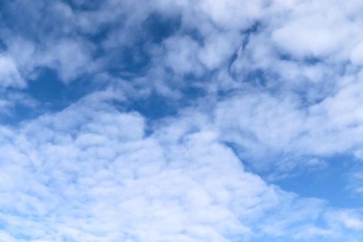 Beautiful fluffy white beautiful cloud formations in a deep blue summer sky