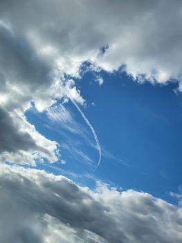 Beautiful fluffy white beautiful cloud formations in a deep blue summer sky