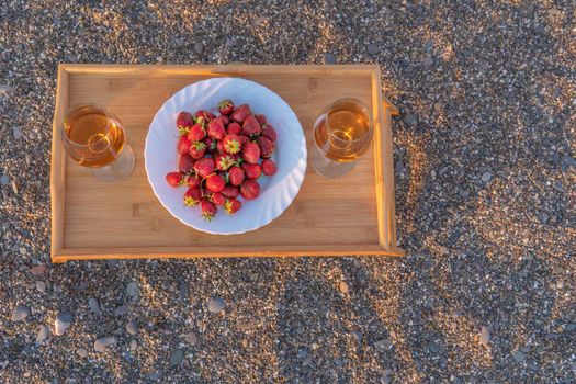 Stones sand bottle wine strawberries pink cheese flat fruit sweet, from summer alcohol from party for celebration appetizer, picnic slice. Holiday dinner rose,
