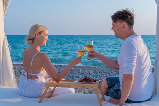 Girl sea together romantic wine guy restaurant rest two rose, from day provence in glass and picnic blue, sky party. Wineglass sunset weekend,