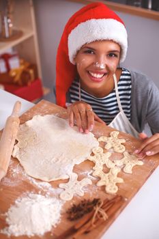 Christmas baking santa woman smiling happy having fun with Christmas preparations wearing Santa hat