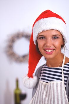 Christmas baking santa woman smiling happy having fun with Christmas preparations wearing Santa hat