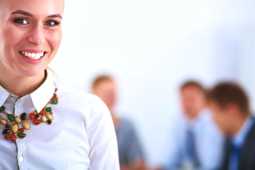 Portrait of a young woman working at office standing .