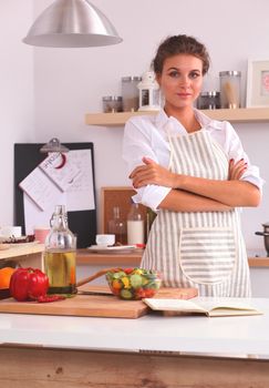 Smiling woman in the kitchen, isolated on christmas background
