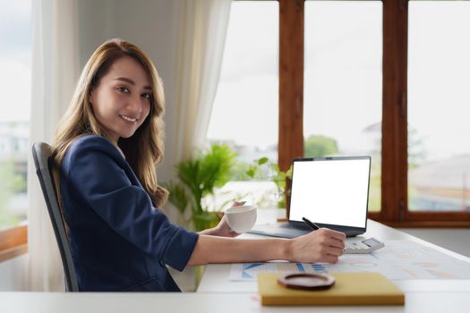 Business Woman analyzes company's financial system and paperwork on desk