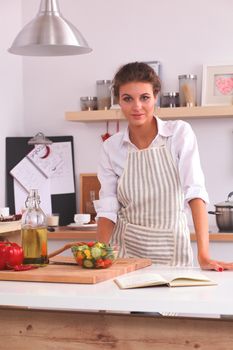 Smiling woman in the kitchen, isolated on christmas background