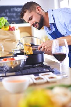 Man preparing delicious and healthy food in the home kitchen.