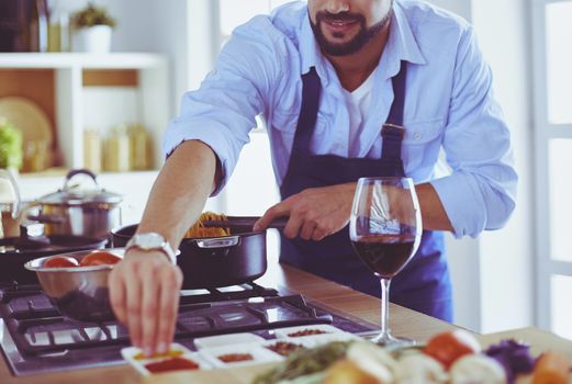 Man preparing delicious and healthy food in the home kitchen.