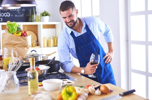 Man preparing delicious and healthy food in the home kitchen.