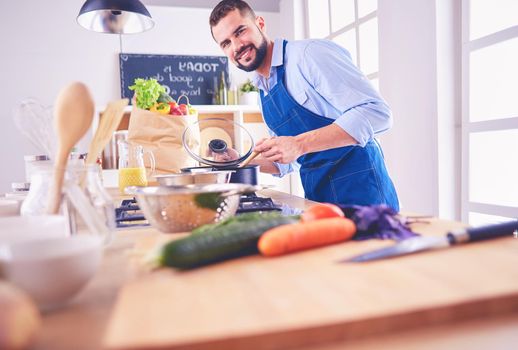 Man preparing delicious and healthy food in the home kitchen.