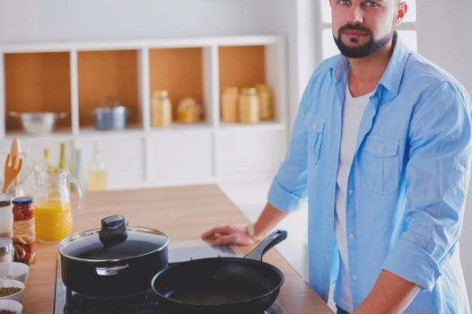 Man preparing delicious and healthy food in the home kitchen.