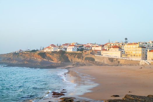 Praia das Macas Apple Beach in Colares, Portugal, on a stormy day before sunset Small city on ocean shore