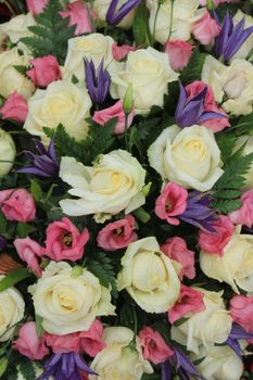 Mixed flower arrangement: various flowers in white and pink for a wedding