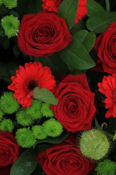 Green red flower arrangement: big red roses and green