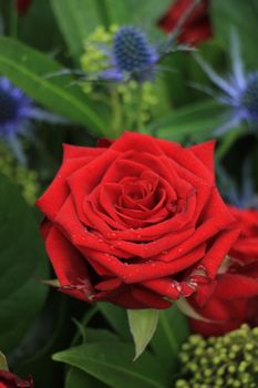 Mixed flower arrangement: various flowers in red and blue for a wedding