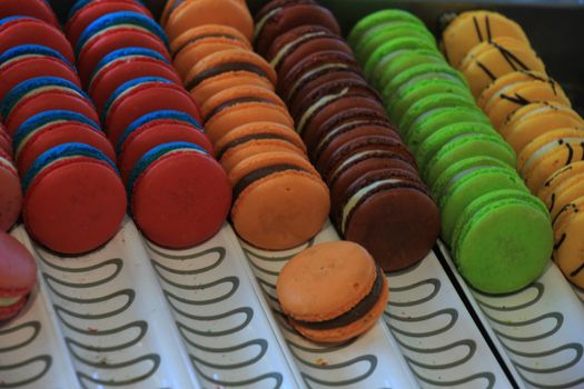 Macarons in various flavors and colors on display in a store